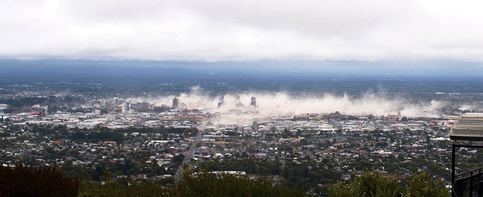 A cloud of debris dust obscuring the city. 2011